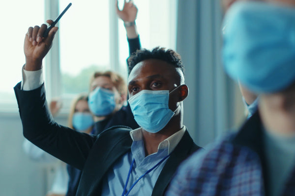 Training session with socially distanced delegates wearing face masks